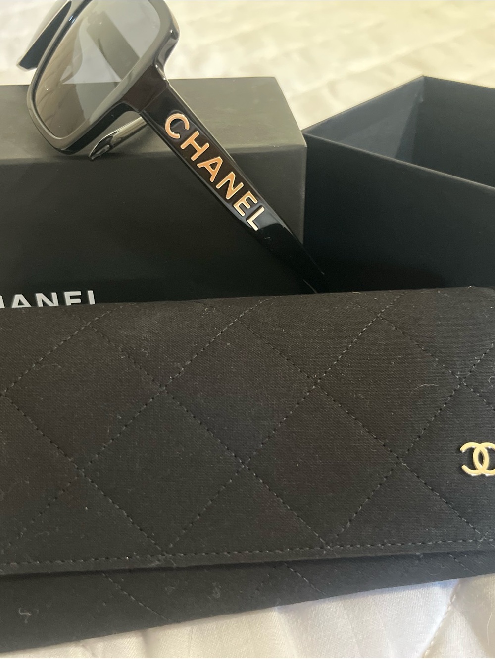CHANEL Black Sunglasses with Gold Lettering